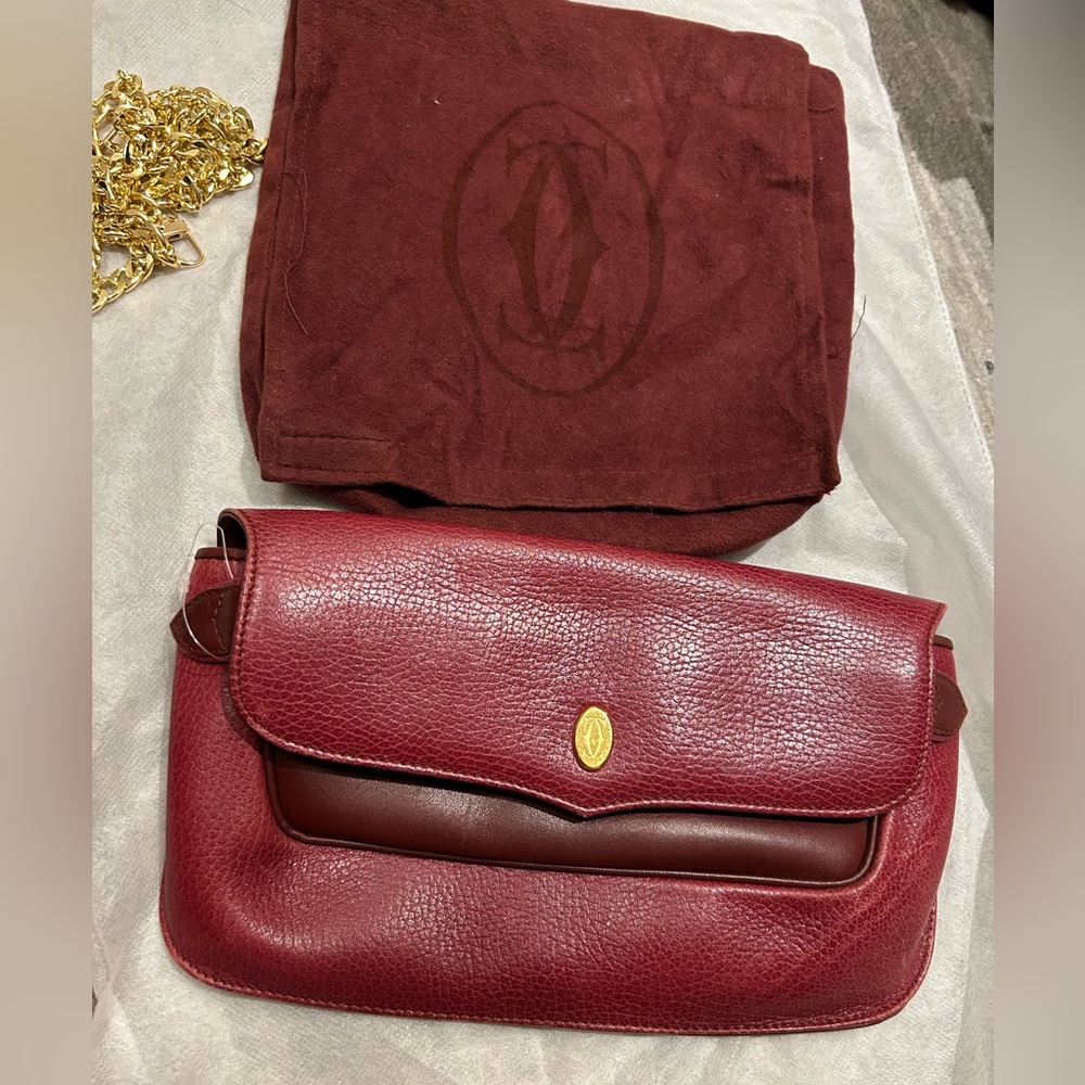 Authentic Cartier Elegant Burgundy Leather clutch 
Free sling